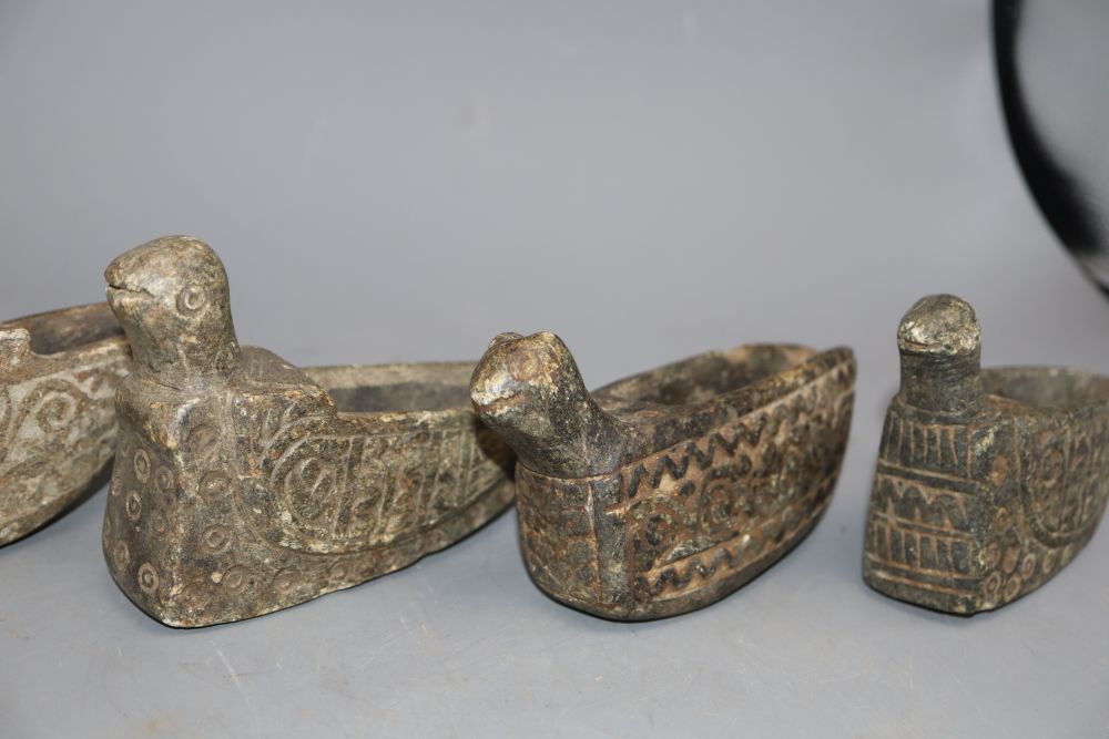 Four Middle Eastern carved stone oil lamps carved in the form of birds, longest 18cm